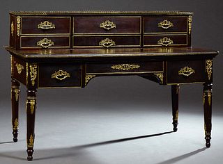 French Ormolu Mounted Carved Mahogany Louis XVI Style Desk, late 19th c., the brass galleried super structure with six deep drawers, on a base with an