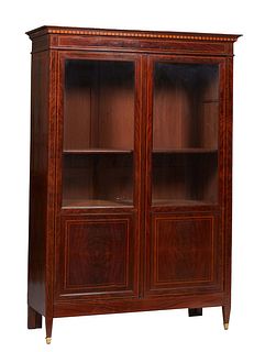 French Louis XVI Style Inlaid Walnut Bookcase, 19th c., the stepped faux dentillated crown over double doors with glazed upper panels over inlaid wood