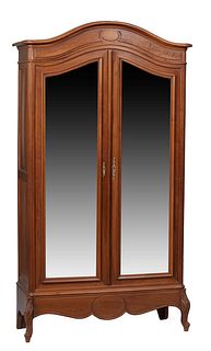 French Provincial Louis XV Style Carved Walnut Armoire, early 20th c., the stepped arched crown over double arched wide beveled mirror doors, flanked 