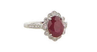 Lady's Platinum Dinner Ring, with a oval 3.0 carat ruby atop a floriform border of small round diamonds, the shoulders of the band also mounted with r