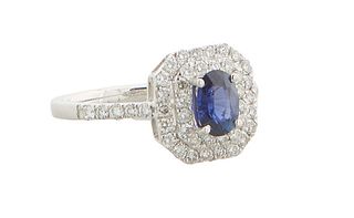 Lady's Platinum Dinner Ring, with an oval 1.8 carat blue sapphire atop a double concentric octagonal border of small round diamonds, the shoulders of 
