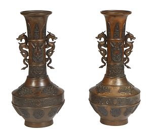 Pair of Japanese Patinated Bronze Baluster Vases, 20th c., the everted rim over a bird relief neck and dragon handle sides, to a baluster bottom with 