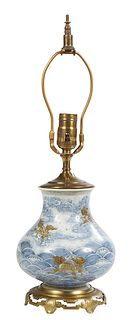 Chinese Porcelain Baluster Vase, 20th c., with Foo dragon decoration on a blue and white ground, mounted on a pierced brass base and wired as a lamp, 