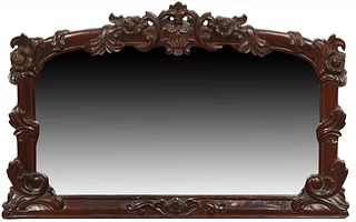 Carved Mahogany Rococo Style Overmantel Mirror, 20th c., with an arched leaf and floral carved top over a wide beveled plate, within floral and leaf c
