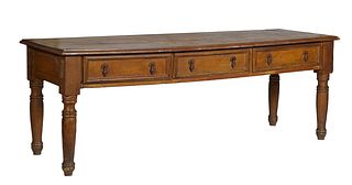 French Provincial Carved Walnut Draper's Table, 19th c., the stepped ogee edge rectangular top over three frieze drawers on one long side, and a deep 