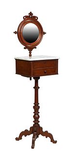 American Victorian Carved Walnut Shaving Stand, late 19th c., with a circular mirror over an ogee edge figured white marble top above two shallow draw