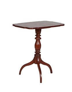 English Carved Mahogany Tilt Top Candlestand, late 19th c., the rectangular rounded corner shaped top on a turned tapered support to tripodal curved l