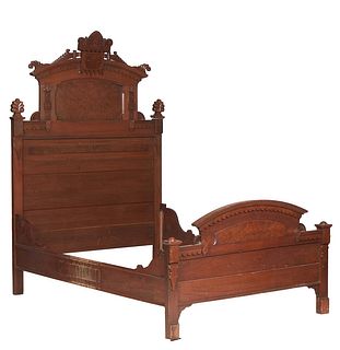 American Eastlake Carved Walnut Three-Quarter Size Highback Bed, c. 1890, the arched incised keystone crest flanked by scrolled finials, over a scallo