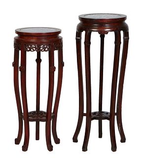 Two Chinese Carved Mahogany Marble Top Pedestals, 20th c., with inset highly figured gray circular marble, the shorter with a pierced skirt, both on c