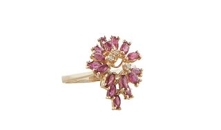 Lady's 14K Yellow Gold Dinner Ring, of diamond shape, with an outer undulating border of fourteen oval rubies around a raised center with three tiny r