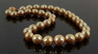 Graduated Strand of Thirty-Three Golden Tahitian Cultured Pearls, ranging from 10-14mm, with a 14K white gold ball clasp, L.- 17 1/2 in., with apprais