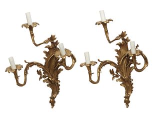 Pair of Louis XV Style Gilt Bronze Three Light Sconces, 19th c., with leaf and scrolled back plates, issuing three curved leaf mounted arms with flori
