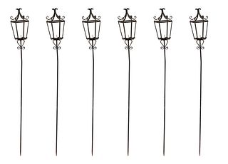 Group of Six Wrought Iron Candle Lanterns, 20th c., the scrolled top over four tapered sides, on cylindrical posts with scrolled bracket supports, H.-