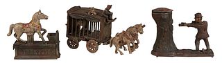 Three Cast Iron Pieces, 20th c., consisting of a "Trick Pony" mechanical coin bank; a mechanical "Hunter and Bear" coin bank; and a "Circus Wagon" wit