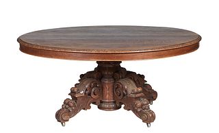 French Henri II Style Carved Oak Dining Table, c. 1880, the stepped oval top on a carved urn support to four fruit and nut carved arched splayed legs,