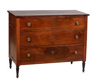 French Louis XVI Style Carved Walnut Commode, 19th c., the rectangular top over three setback graduated drawers with ormolu pulls and shield escutcheo