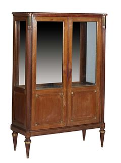 French Louis XVI Style Ormolu Mounted Carved Walnut Vitrine, 20th c., the cookie corner top over double doors with glazed upper panels over lower wood