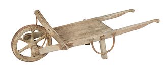French Provincial Carved Poplar Wheelbarrow, late 19th c., H.- 22 in., W.- 68 in., D.- 28 in.