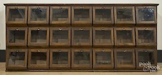Oak country store seed counter, ca. 1900, with twenty-one drawers and glass panes, 54'' h., 120'' w.