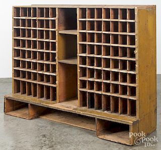 Painted pine post office cubby hole cabinet, 19th c., retaining an old mustard surface