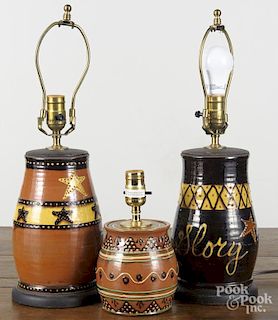 Three contemporary Turtle creek redware table lamps, 10'' h., 6'' h., and 10 1/4'' h.