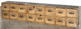 Large painted pine country store spice cupboard with two rows of labeled drawers