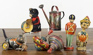 Tin wind-up toys, 20th c., to include a Marx Pinocchio, a Chein band leader, a Marx cat with a ball