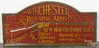 Reproduction Winchester Repeating Arms Co. painted wood sign with a relief carved rifle