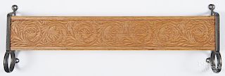 Pressed oak wall shelf with cast iron ends, ca. 1900, includes a circular opening for a towel bar
