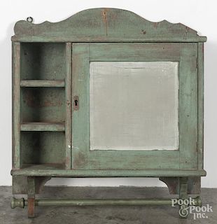 Pennsylvania painted pine hanging cupboard, 19th c., retaining an old green surface, 23'' h., 22'' w.