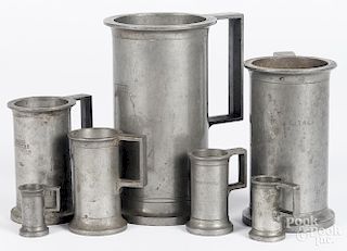 Seven graduated pewter measures, tallest - 7 1/4''.