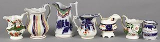 Seven Gaudy Welsh pitchers and creamers, patterns to include Ross, Anglesey, Pendine, Wagon Wheel