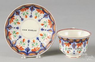 Gaudy Welsh tea cup and saucer, 19th c., in the Fairy Glenn pattern, both inscribed Ann Singlar.