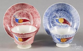 Two spatter peafowl cups and saucers, 19th c., one red and one blue.