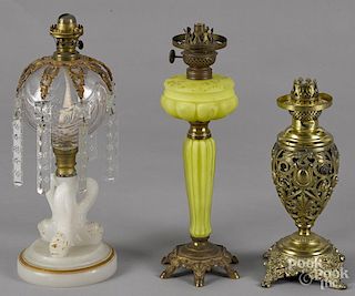 Three fluid lamps, 19th c., to include one pierced brass, one with a dolphin base, and one yellow