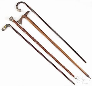 Four walking sticks, late 19th/early 20th c., to include one presentation stick with a sterling cap