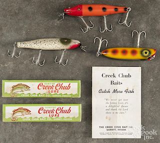 Two Creek Chub glass eyes pikie wood fishing lures, to include one in orange and red