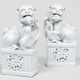 Pair of Chinese White Glazed Buddhist Lions on Pierced Bases