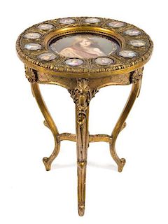 A Louis XV Style Porcelain and Gilt Bronze Mounted Giltwood Gueridon Height 29 x diameter 21 1/2 inches.