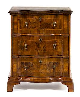 An Austrian Walnut Veneered Chest of Drawers Height 31 inches.