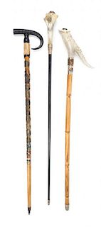 Three Sword Canes Length of longest 36 1/4 inches.