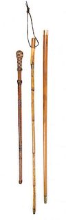 Two Metal Mounted Bamboo Sword Canes Length of longest 33 1/2 inches.