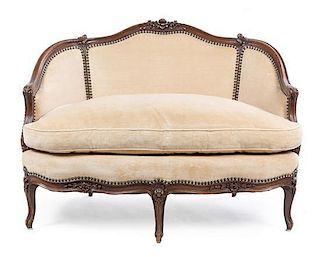 * A Louis XV Style Walnut Settee Height 31 inches.