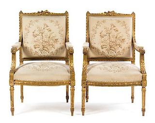 * A Pair of Louis XVI Style Giltwood Fauteuils Height 38 x width 24 1/2 x depth 19 inches.