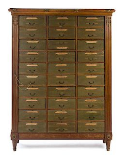* A Louis XVI Style Parcel Gilt Walnut Cabinet Height 75 1/2 x width 56 3/4 x depth 16 7/8 inches.