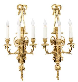A Pair of Louis XVI Style Gilt Bronze Three-Light Sconces Length 27 inches.