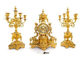 A French Gilt Bronze Clock Garniture Height of candelabra 24 1/2 inches.