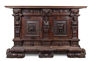 * A German Relief Carved Oak Cabinet Height 55 3/4 x width 86 1/2 x depth 27 1/4 inches.