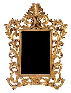 * An Italian Baroque Style Giltwood Mirror Height 45 x width 42 inches.