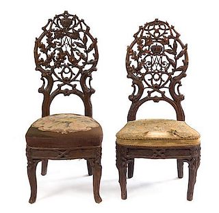 A Pair of Black Forest Pierce Carved Side Chairs Height of tallest 41 1/4 inches.